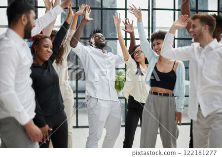 Colleagues celebrating good news in modern office 122181277