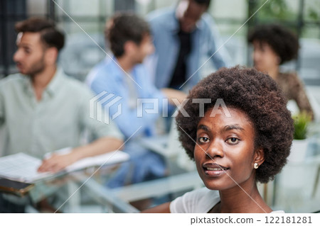 business woman with her staff in background at office 122181281