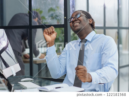 happy man working in the office. raised his hands joyfully happy man working in the office. raised his hands joyfully 122181568