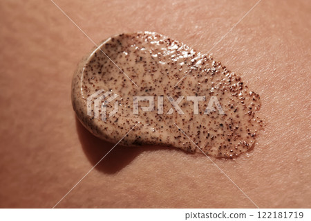 Coffee cream scrub on human skin close-up. Coffee cream scrub on human skin close-up. 122181719