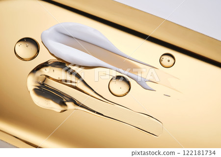The texture of cream and serum on a golden background. 122181734