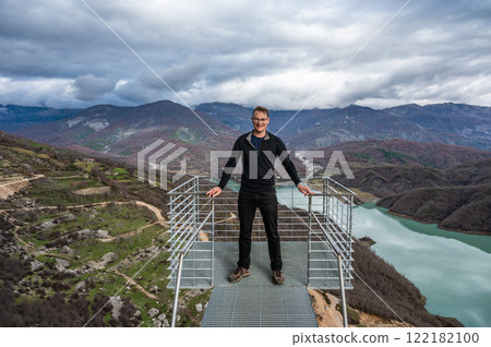 45 yo sporty tourist standing on a panoramic looking platform at the Gamti mountains, Albania. 45 yo sporty tourist standing on a panoramic looking platform at the Gamti mountains, Albania. 122182100
