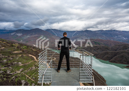 45 yo sporty tourist standing on a panoramic looking platform at the Gamti mountains, Albania. 45 yo sporty tourist standing on a panoramic looking platform at the Gamti mountains, Albania. 122182101