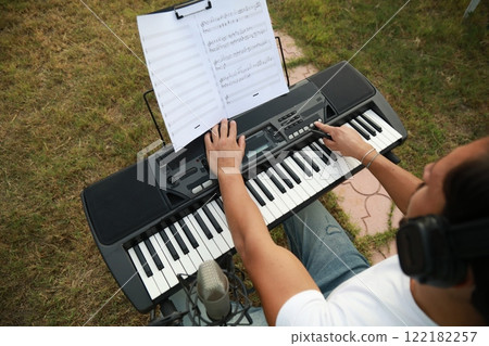 Boy Pianist Plays The Keyboard In An Outdoor Garden For A Private Party 122182257