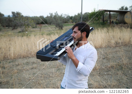 Italian Boy Walks Playing Musical Keyboard On Shoulder In Nature Calabria 122182265