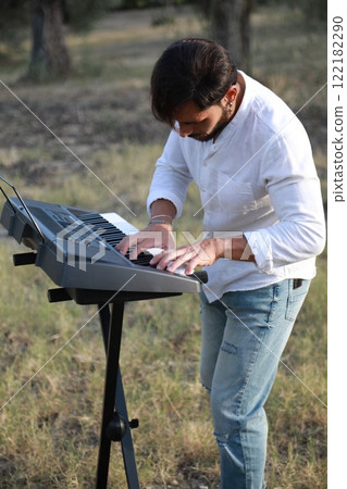 Man Plays The Musical Keyboard In The Countryside In Calabria Among Olive Trees 122182290