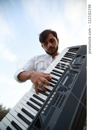Keyboard Player Standing In Nature With Olive Trees In Calabria 122182296