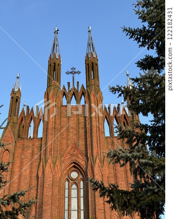 Neo-Gothic Brick Church with Towering Spires 122182431