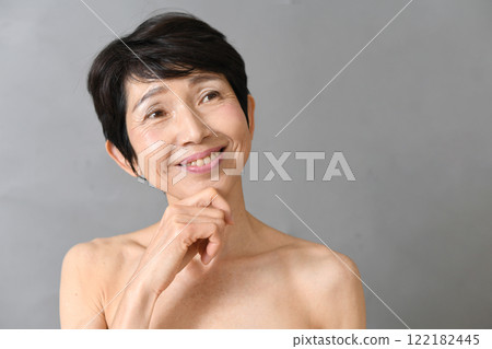 Thinking middle-aged Asian woman skin care 122182445