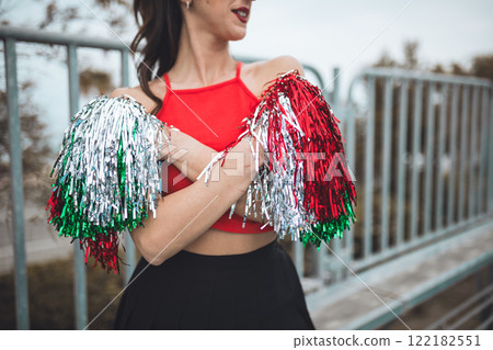 Cheerleader Girl Cheers Her Heart Team With Pompon In Football Stadium Cheerleader Girl Cheers Her Heart Team With Pompon In Football Stadium 122182551