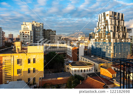 High angle view over colorful apartment blocks and mountains at dusk in the city of Tirana, Albania High angle view over colorful apartment blocks and mountains at dusk in the city of Tirana, Albania 122182698