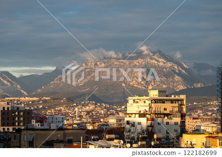 High angle view over colorful apartment blocks and mountains at dusk in the city of Tirana, Albania High angle view over colorful apartment blocks and mountains at dusk in the city of Tirana, Albania 122182699