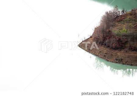 Reflections of mountain slope and brown soil in the Bovilla lake, Albania Reflections of mountain slope and brown soil in the Bovilla lake, Albania 122182748