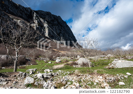 Fallen stone and rock formation with a mountain background at Gamti Mountain, Albania Fallen stone and rock formation with a mountain background at Gamti Mountain, Albania 122182790