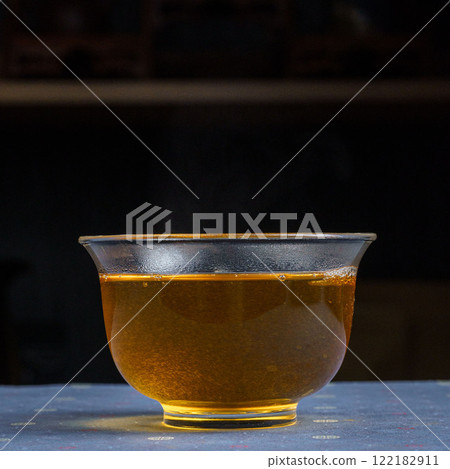 A warm herbal infusion presented beautifully in a glass bowl for enhanced enjoyment A warm herbal infusion presented beautifully in a glass bowl for enhanced enjoyment 122182911