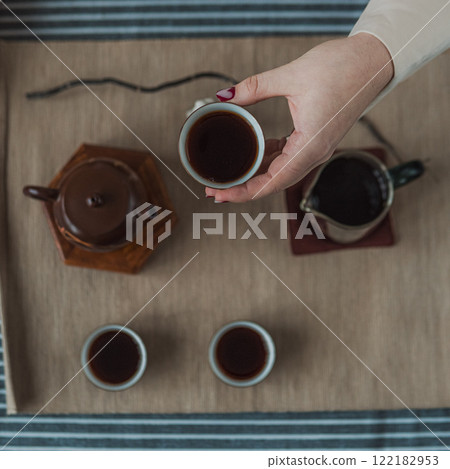 A beautiful and elegant tea ceremony featuring a traditional teapot and matching tea cups 122182953