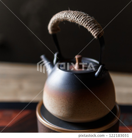 Beautifully designed and elegant Japanese Tea Kettle comes with a charming woven handle 122183031