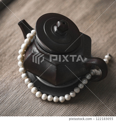 An Elegant Black Teapot that is adorned with Beautiful Pearls for an exquisite appearance 122183055