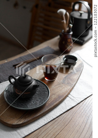A beautiful and serene tea set arrangement showcased elegantly on a wooden tray A beautiful and serene tea set arrangement showcased elegantly on a wooden tray 122183072