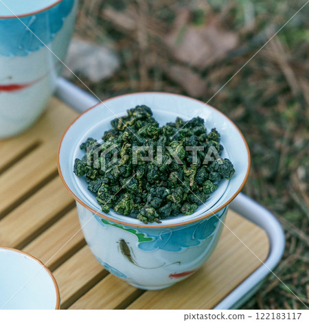 The exquisite Traditional Oolong Tea Leaves beautifully displayed in a delicate Chinese Teacup 122183117