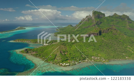 Aerial drone of breathtaking beauty of Bora Bora, with its lush green vegetation, crystal clear turquoise water, and majestic mount Otemanu dominating tropical landscape. Wild nature paradise Aerial drone of breathtaking beauty of Bora Bora, with its lush green vegetation, crystal clear turquoise water, and majestic mount Otemanu dominating tropical landscape. Wild nature paradise 122183338