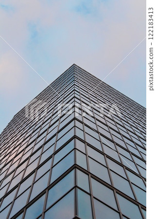 modern skyscraper with glass panoramic windows in the business district of the European capital, wide angle view of a high-rise office building in the financial center of the city during the day 122183413