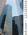 modern skyscrapers with glass panoramic windows in the financial center of the city, wide angle view of a high rise office buildings in the business district of the European capital during the day 122183418