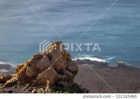 Rock on a cliff and Atlantic ocean, Lanzarote, Spain 122183460