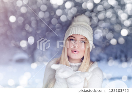 Blonde woman wearing warm mittens, knitted beanie hat and jumper, winter snow nature background with copyspace fashion and lifestyle idea 122183753
