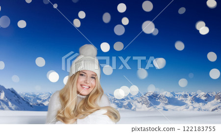 Blonde woman wearing warm mittens, knitted beanie hat and jumper, winter snow nature background with copyspace fashion and lifestyle idea 122183755