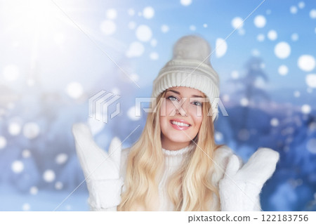 Blonde woman wearing warm mittens, knitted beanie hat and jumper, winter snow nature background with copyspace fashion and lifestyle idea Blonde woman wearing warm mittens, knitted beanie hat and jumper, winter snow nature background with copyspace fashion and lifestyle idea 122183756