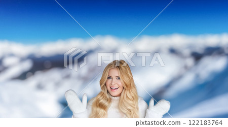 Blonde woman wearing warm mittens, knitted beanie hat and jumper, winter snow nature background with copyspace fashion and lifestyle idea Blonde woman wearing warm mittens, knitted beanie hat and jumper, winter snow nature background with copyspace fashion and lifestyle idea 122183764