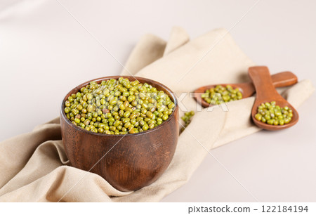 Protein-rich mung beans in a wooden bowl on beige table 122184194