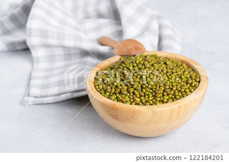 Mung beans in a bowl on light background Mung beans in a bowl on light background 122184201