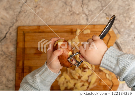 Child Peeling Potato Child Peeling Potato 122184359
