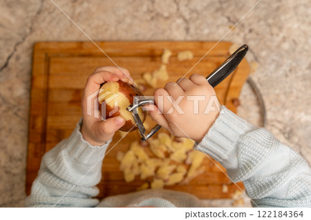Child Peeling Potato Child Peeling Potato 122184364
