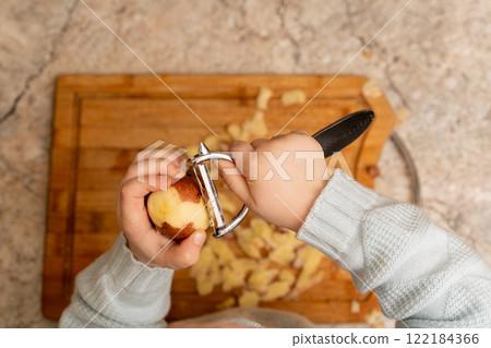 Child Peeling Potato 122184366