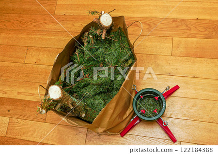 Christmas tree sawn into pieces in a paper bag, concept of Christmas tree utilization after holidays Christmas tree sawn into pieces in a paper bag, concept of Christmas tree utilization after holidays 122184388