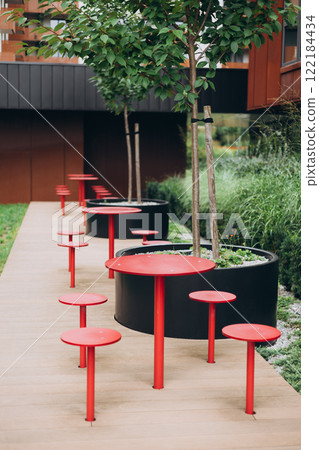 Outdoor street cafe red tables ready for service. Modern Empty cafe terrace with table and chair, morning time. Food concept. Outdoor street cafe red tables ready for service. Modern Empty cafe terrace with table and chair, morning time. Food concept. 122184434