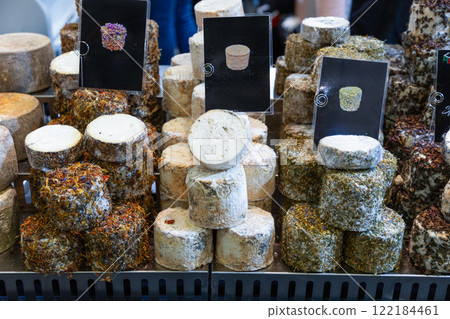 several different varieties of farmer's cheese lie on counter ready for sale several different varieties of farmer's cheese lie on counter ready for sale 122184461