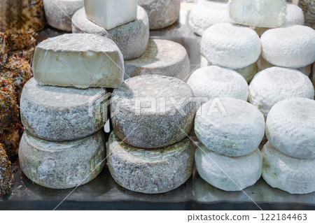 several different varieties of farmer's cheese lie on counter ready for sale several different varieties of farmer's cheese lie on counter ready for sale 122184463