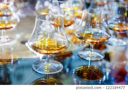 many glasses with strong alcohol stand on the table ready to drink many glasses with strong alcohol stand on the table ready to drink 122184477