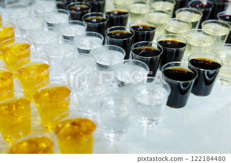 many glasses with strong alcohol stand on the table ready to drink many glasses with strong alcohol stand on the table ready to drink 122184480