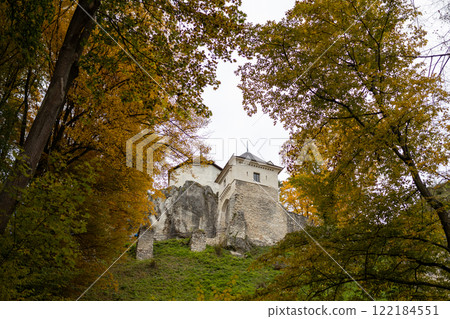 View of castle in autumn fall colors of trees in Ojcow National Park, Poland. View of castle in autumn fall colors of trees in Ojcow National Park, Poland. 122184551