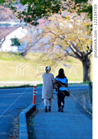 Woman walking in the park Parking lot Woman walking in the park Parking lot 122184789