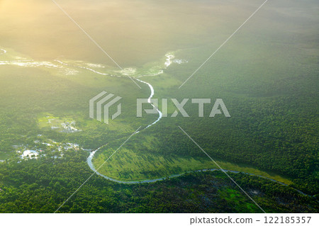 Scenic Tributary of the Demerara River Winding through the Amazon Rainforest in Guyana, South American Scenic Tributary of the Demerara River Winding through the Amazon Rainforest in Guyana, South American 122185357