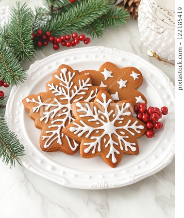 Childs hand holding a glittery transparent ornament with blurry Christmas lights behind winter holiday decor 122185419