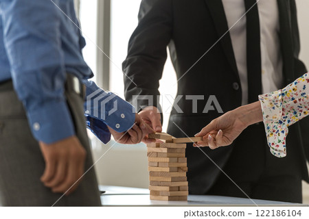 Business team of three businesspeople working together to build a tower Business team of three businesspeople working together to build a tower 122186104