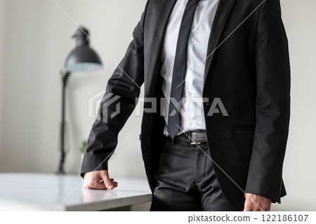 Businessman standing in his office waiting 122186107