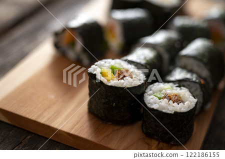 Fresh sushi rolls on wooden board 122186155